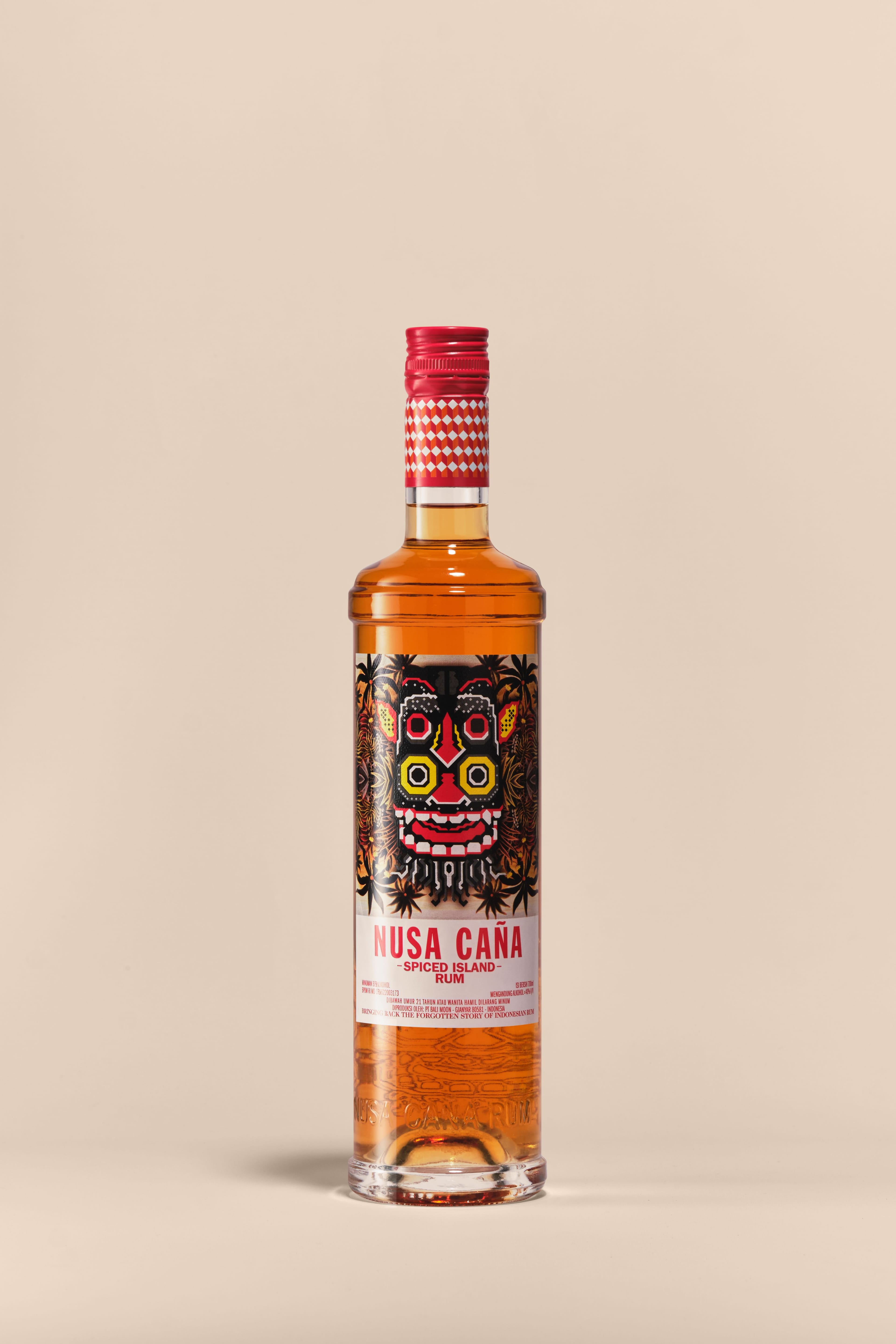 Nusa Caña Spiced Island rum bottle with a beige background.